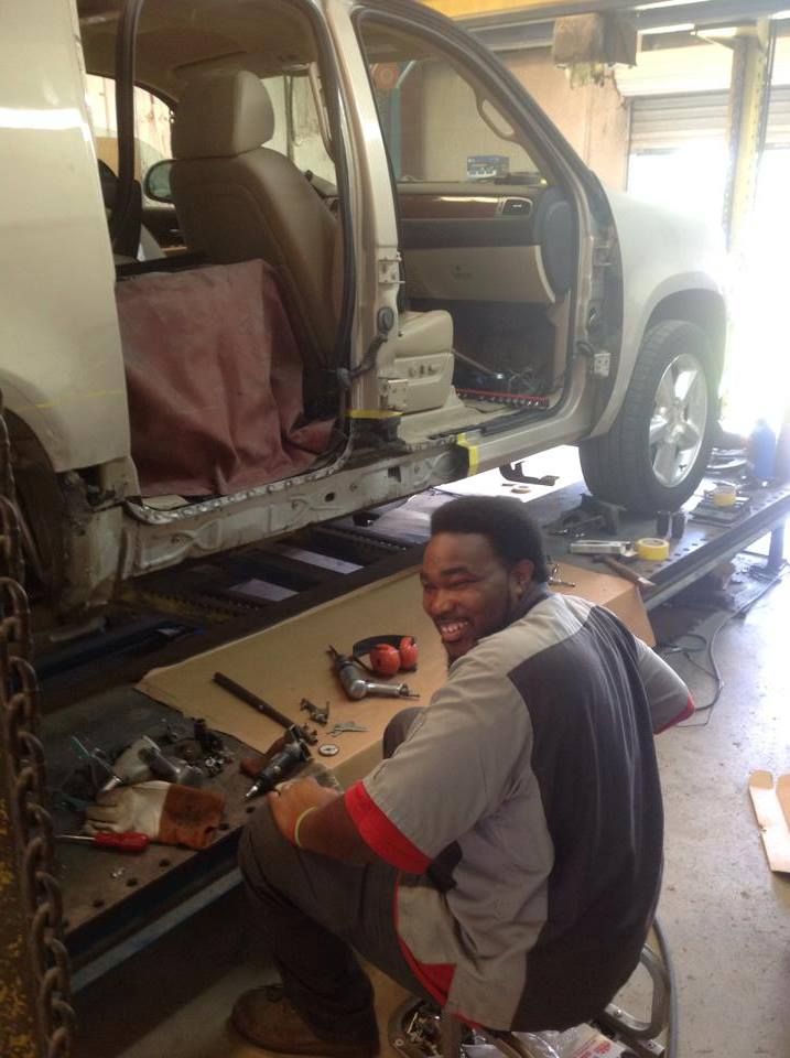 A man is working on a car in a garage