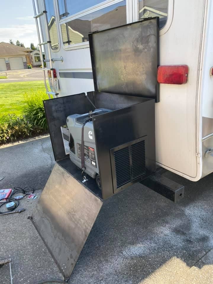 A generator is attached to the back of a rv.