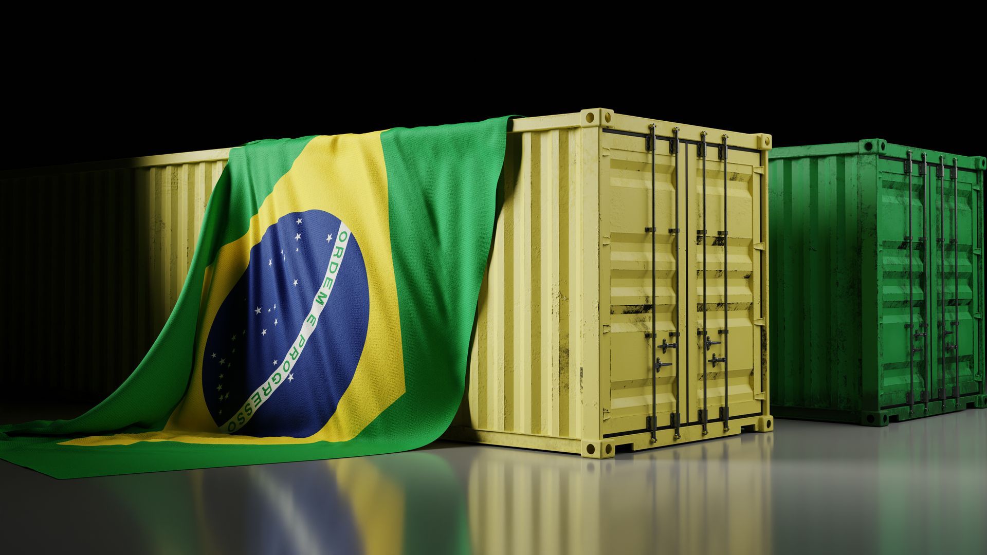 Uma fileira de contêineres cobertos por uma bandeira brasileira.
