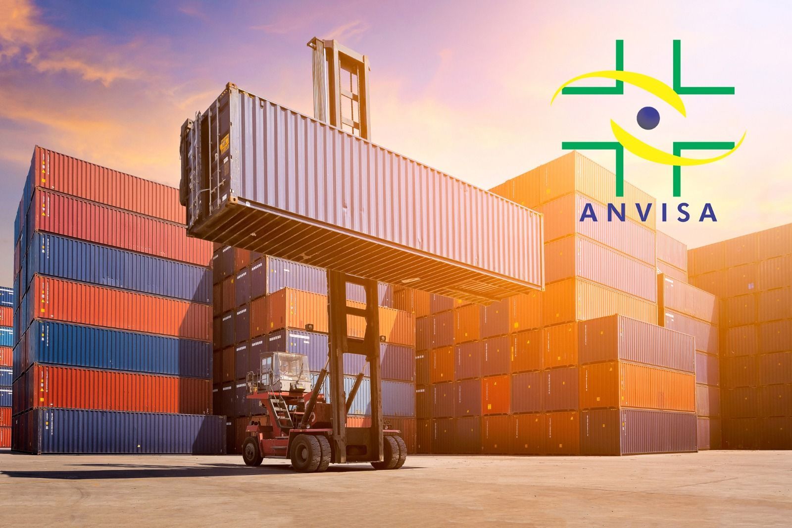 A forklift is lifting a shipping container in front of a building.