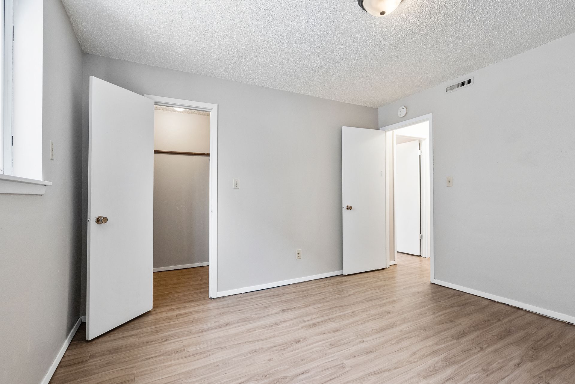 photo of a bedroom, taken from back wall