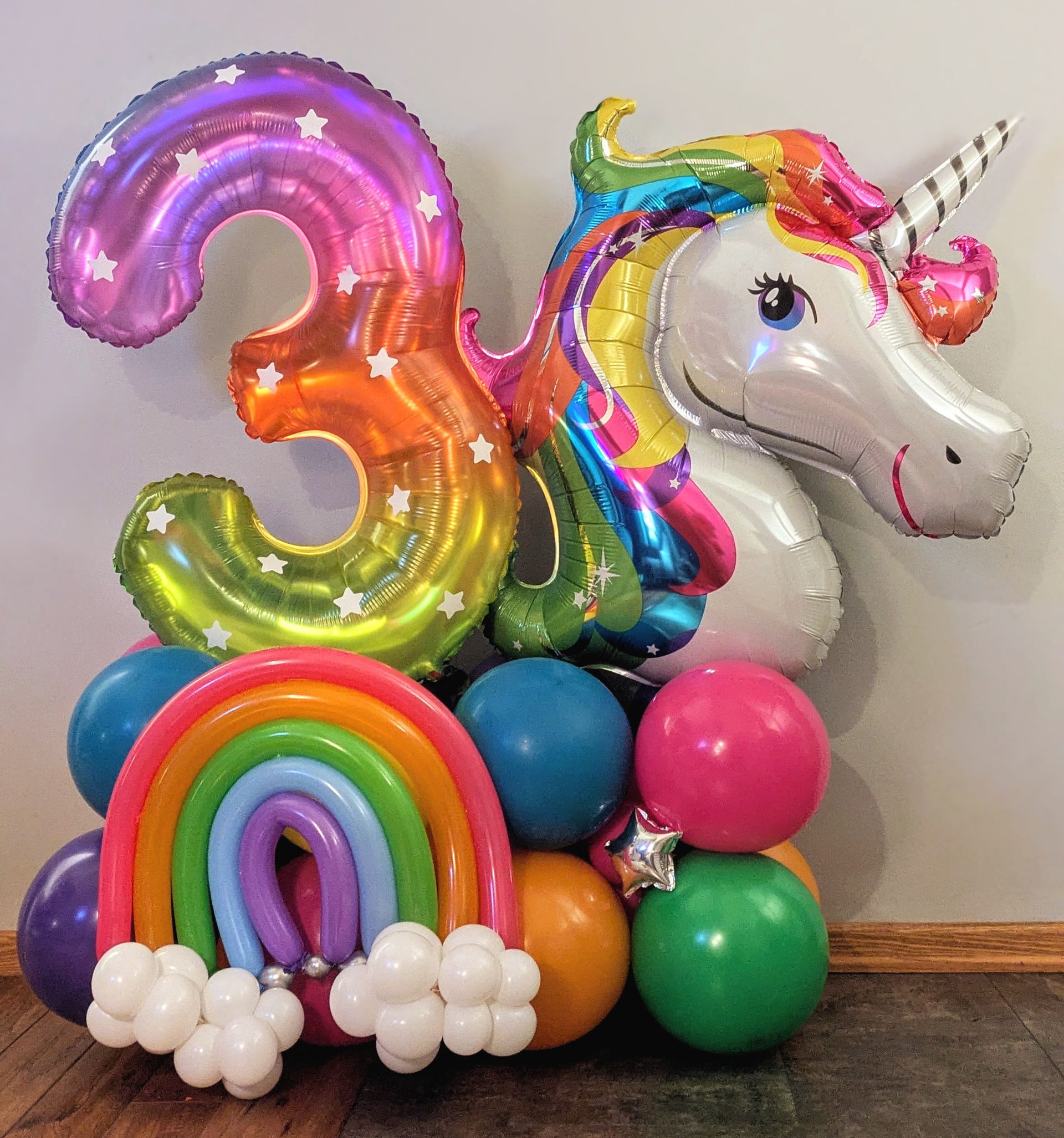 A colorful unicorn-themed balloon display 