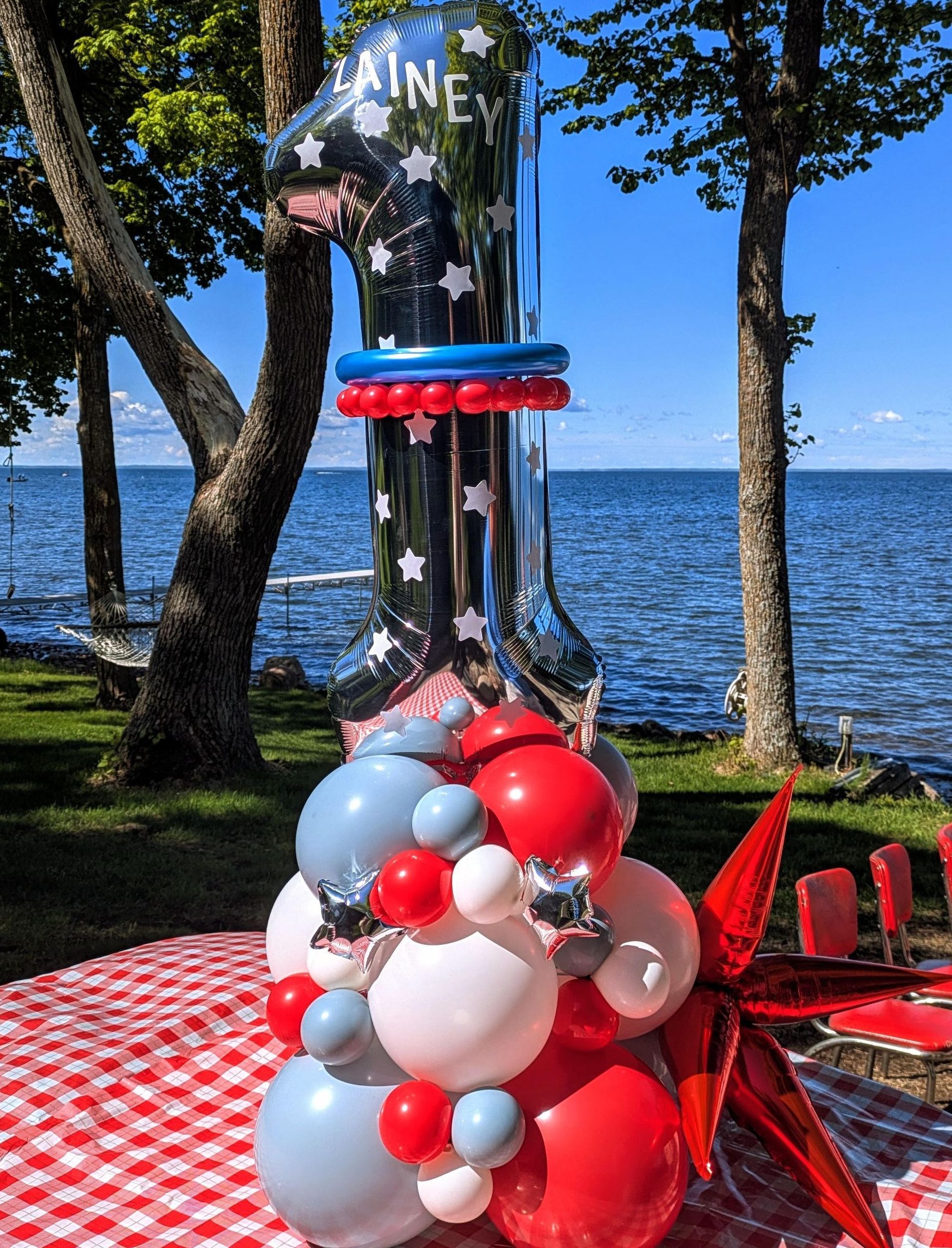 A festive balloon display in red, white, and blue