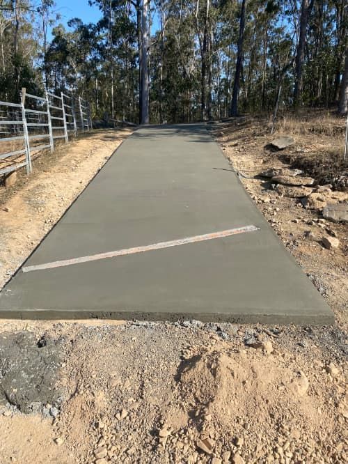 A concrete driveway is being built in the middle of a forest — Shaka Concreting In South Golden Beach, NSW