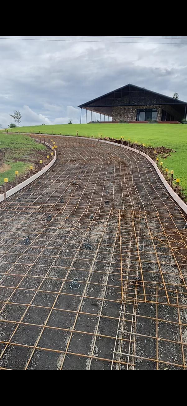A Dirt Road Leading to A House on Top of A Hill — Shaka Concreting In South Golden Beach, NSW
