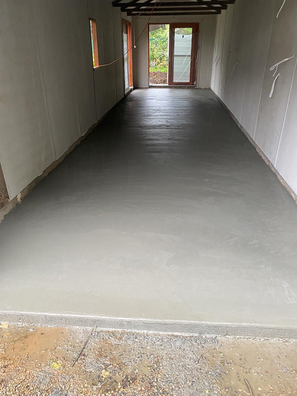 A Garage with A Concrete Floor and A Door — Shaka Concreting In South Golden Beach, NSW