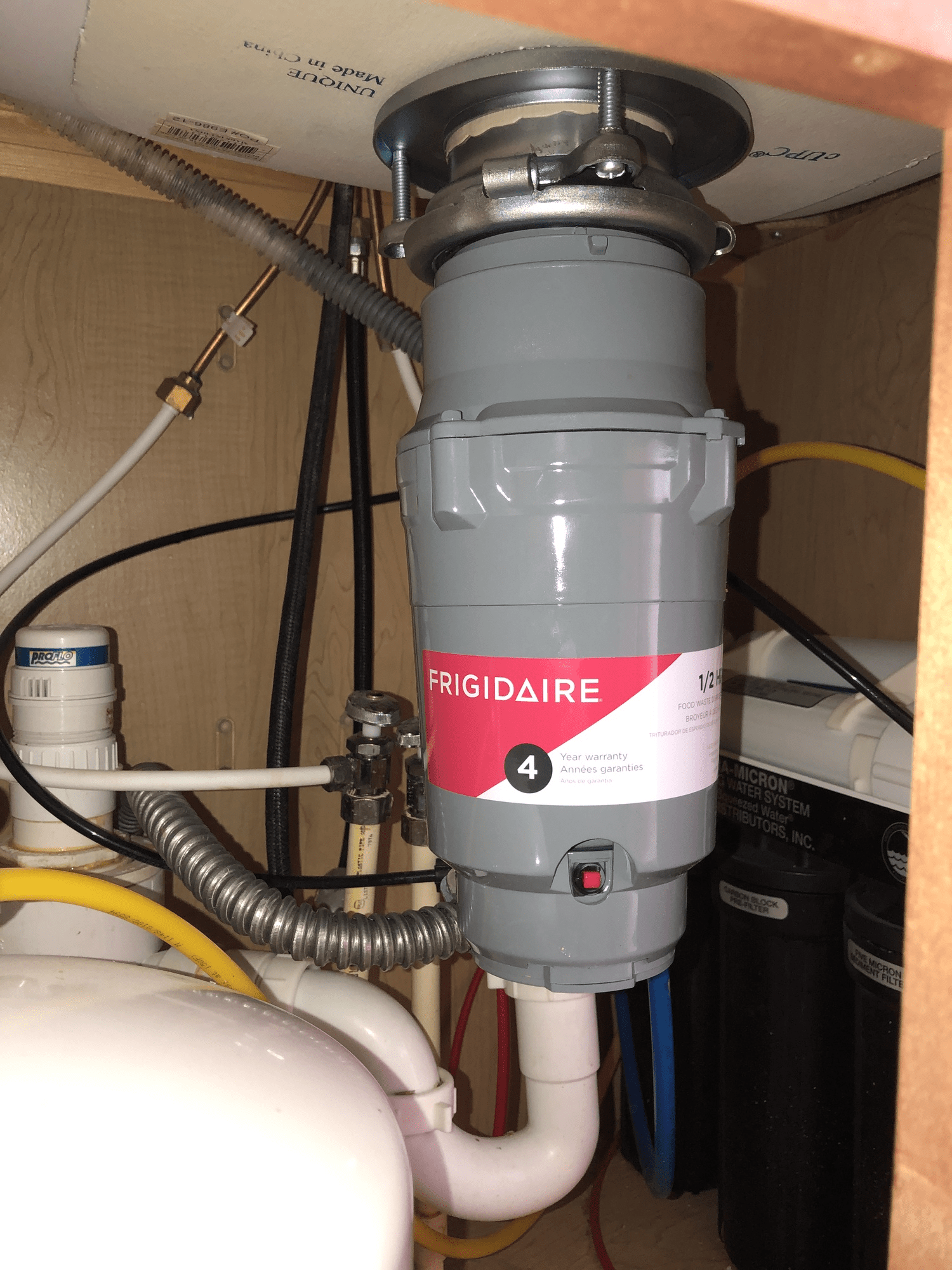 A garbage disposal is sitting under a sink in a kitchen.