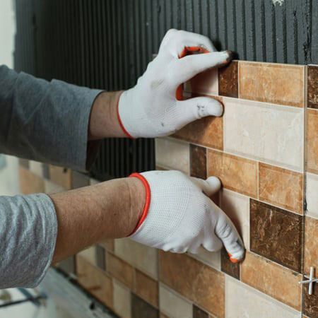 man placing new tiles man placing new tiles