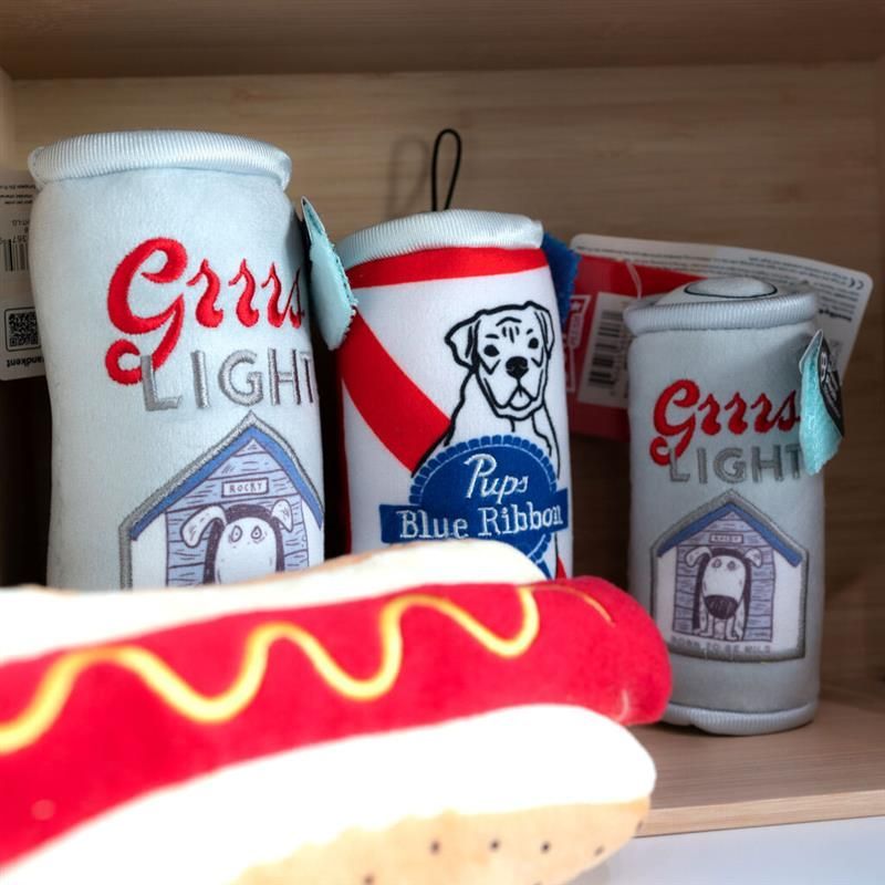 A shelf with stuffed cans of bud light and a hot dog