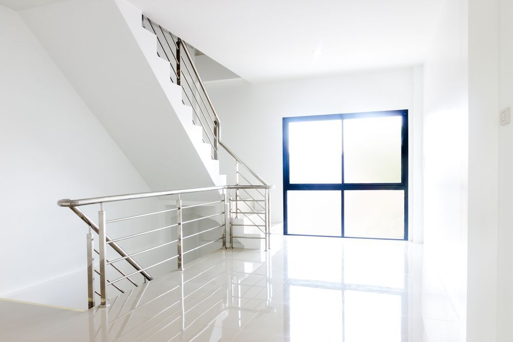 Bright, White Interior with Staircase and Window — Shaun Steenson Building Services in Townsville, QLD