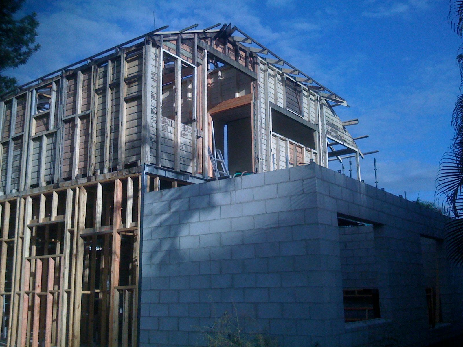 Partially Constructed House with Exposed Wood Framing and Gray Cinder Block Walls — SS Building Services in Townsville, QLD