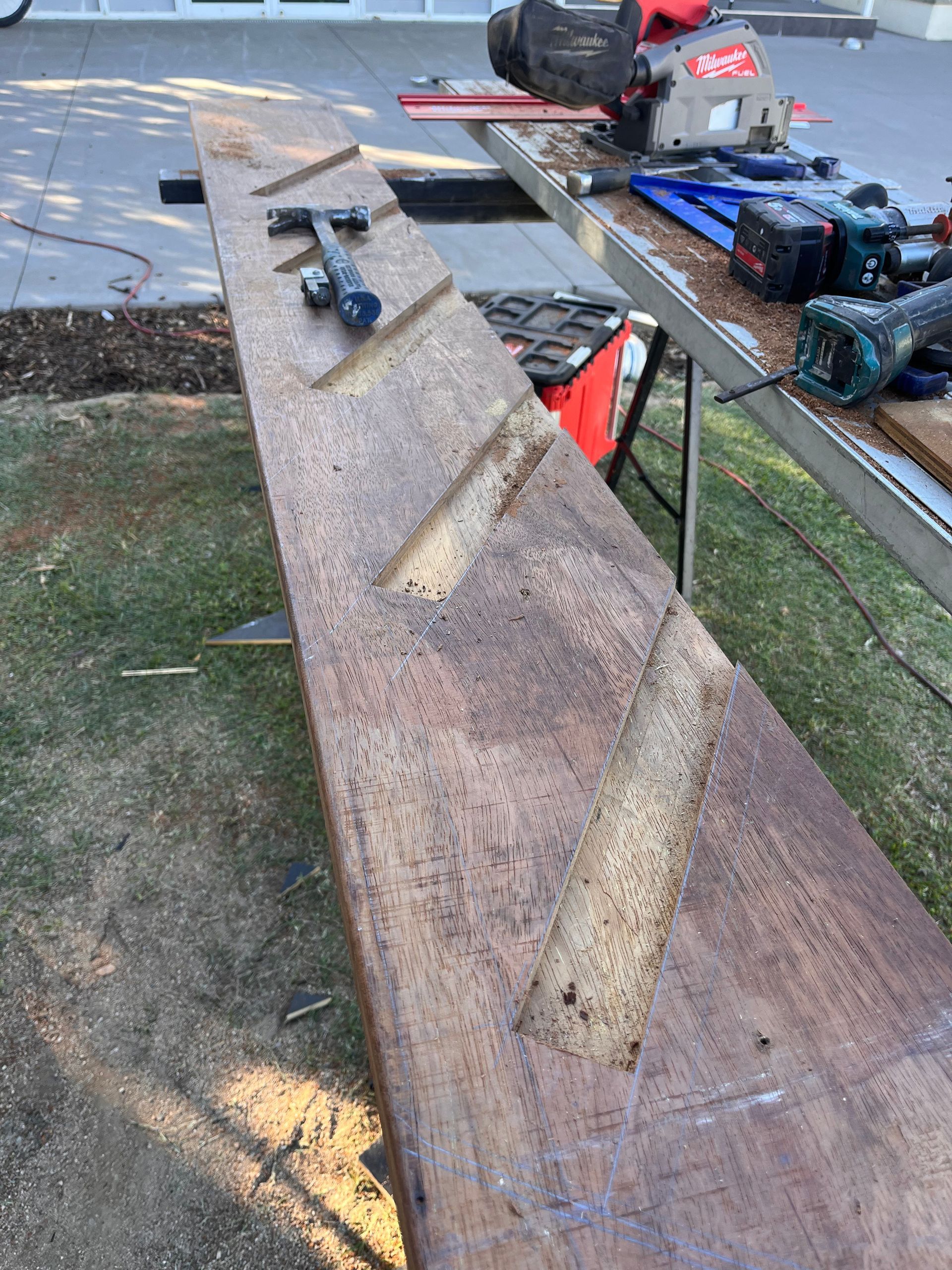 Person Wearing Gloves Sanding a Wooden Frame — Shaun Steenson Building Services in Townsville, QLD