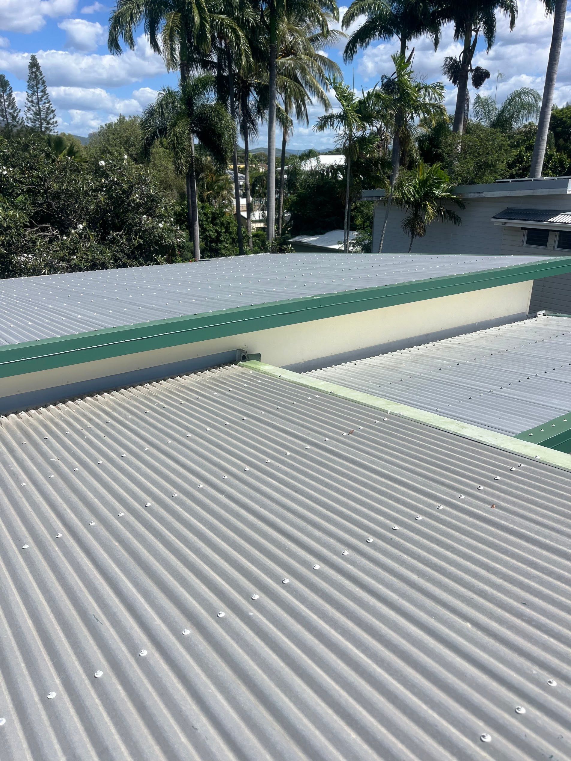 Corrugated Metal Rooftops with A Green Trim — SS Building Services in Townsville, QLD
