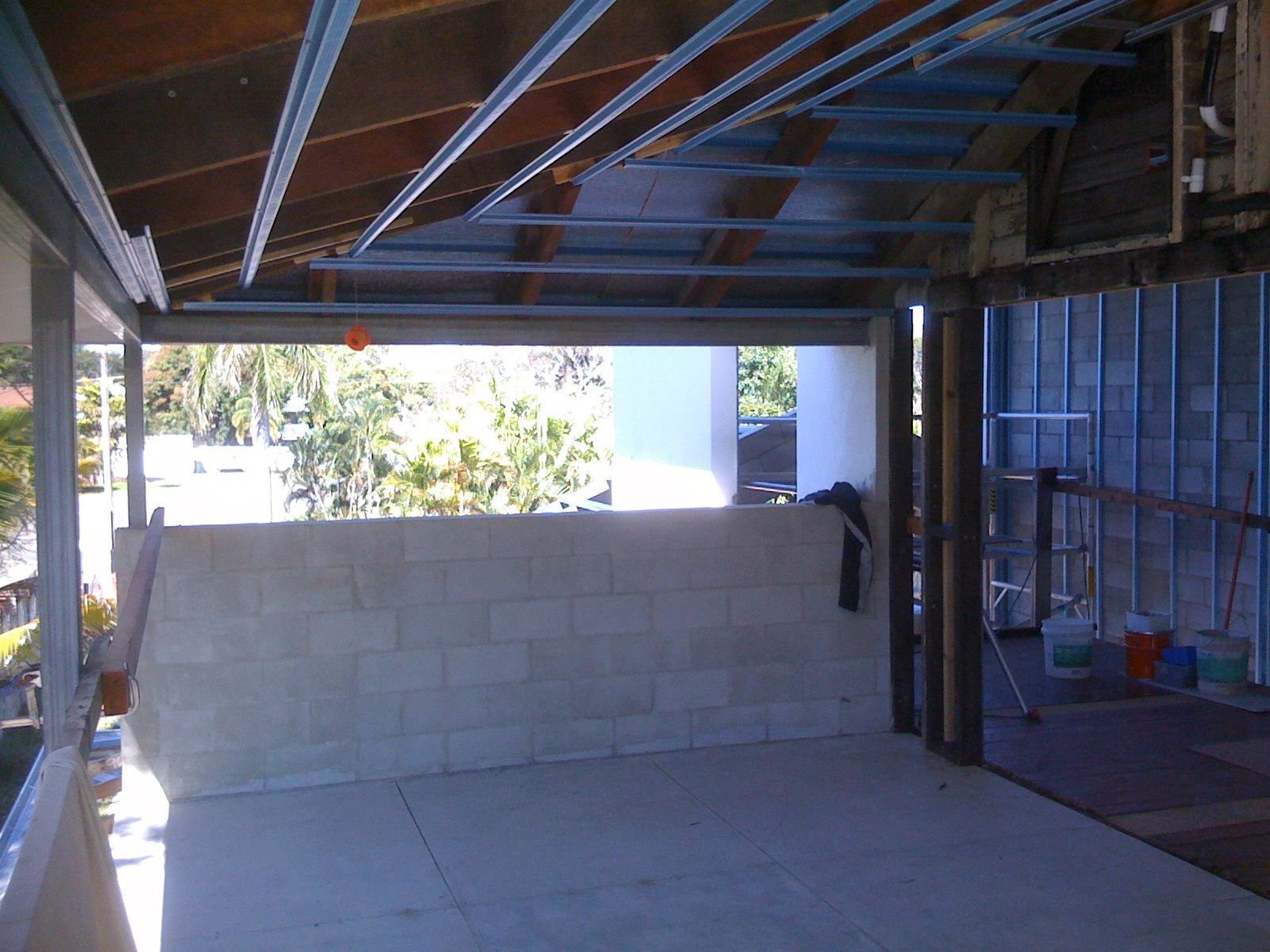 Partially Built Garage Interior with Exposed Beams and Tools Along the Right Side — SS Building Services in Townsville, QLD