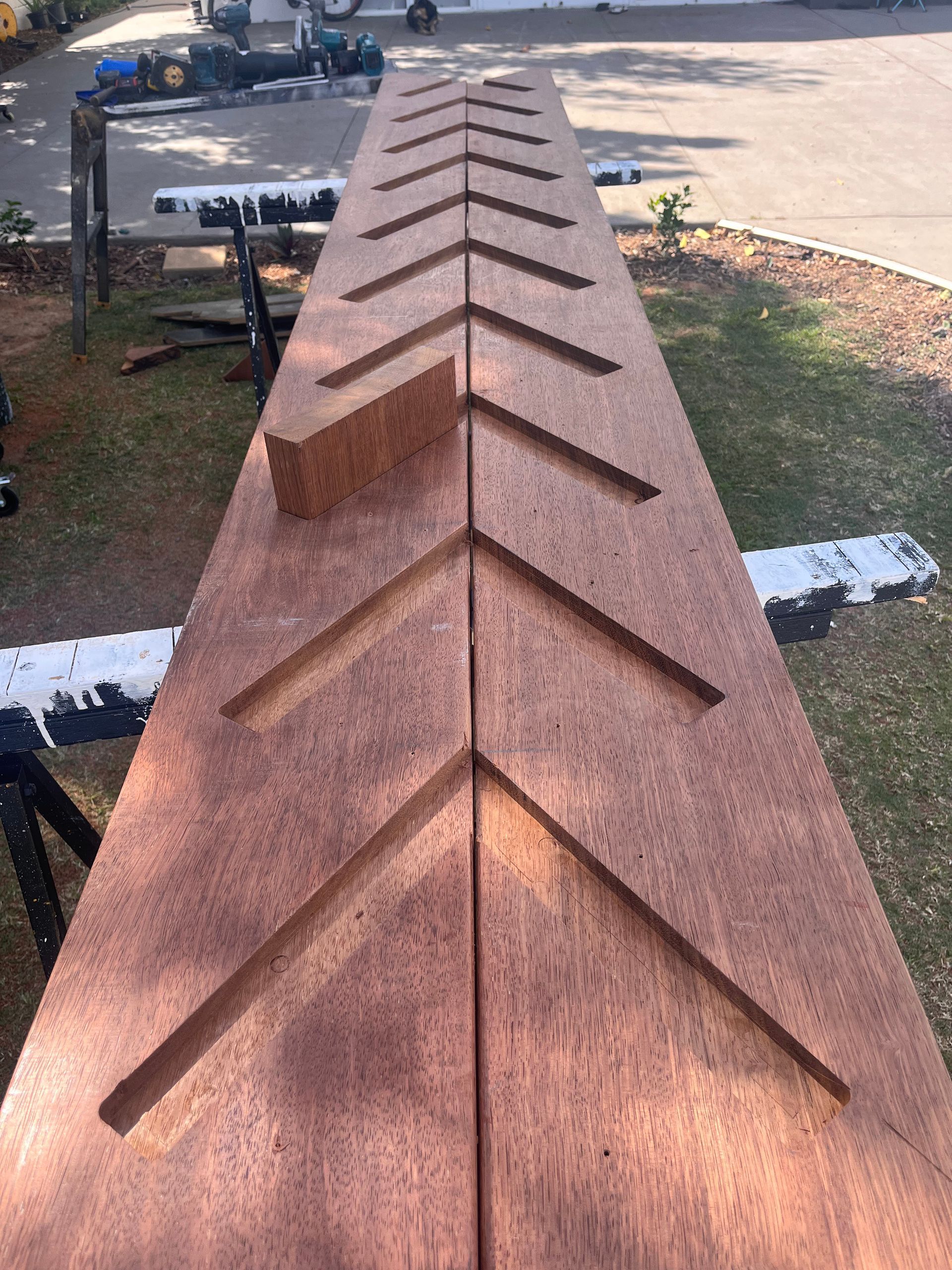 Rust-colored shingled roof ridge with repeating triangular vents outdoors in sunlight — SS Building Services in Townsville, QLD