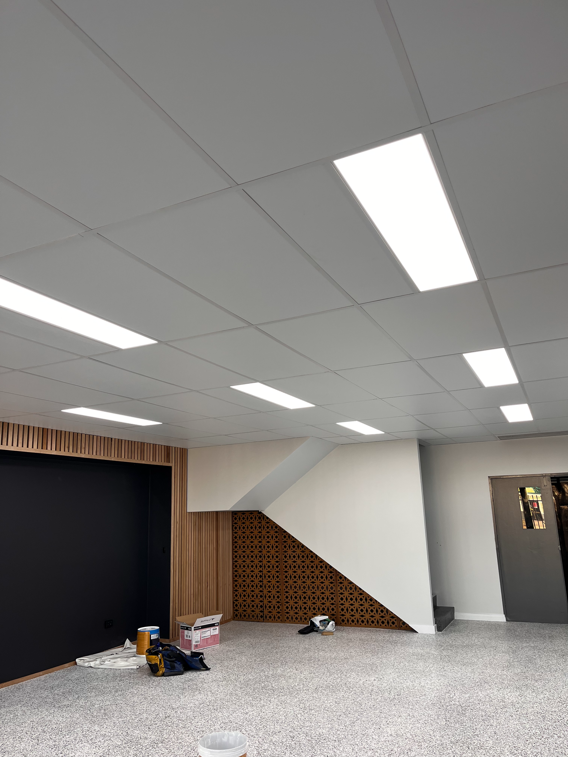 An Empty Room With Stairs Leading Up to the Second Floor — Shaun Steenson Building Services in Townsville, QLD