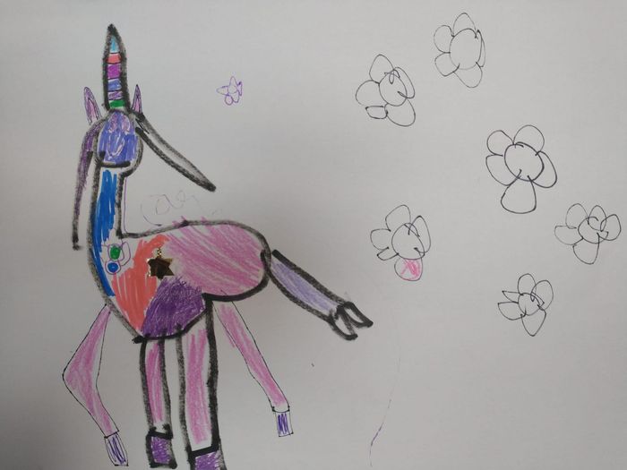 Play-Doh set with blue tray, rolling pin, various cutters, and colorful play-doh pieces on a wooden surface.