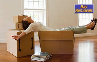 bay removals woman reclining on moving boxes