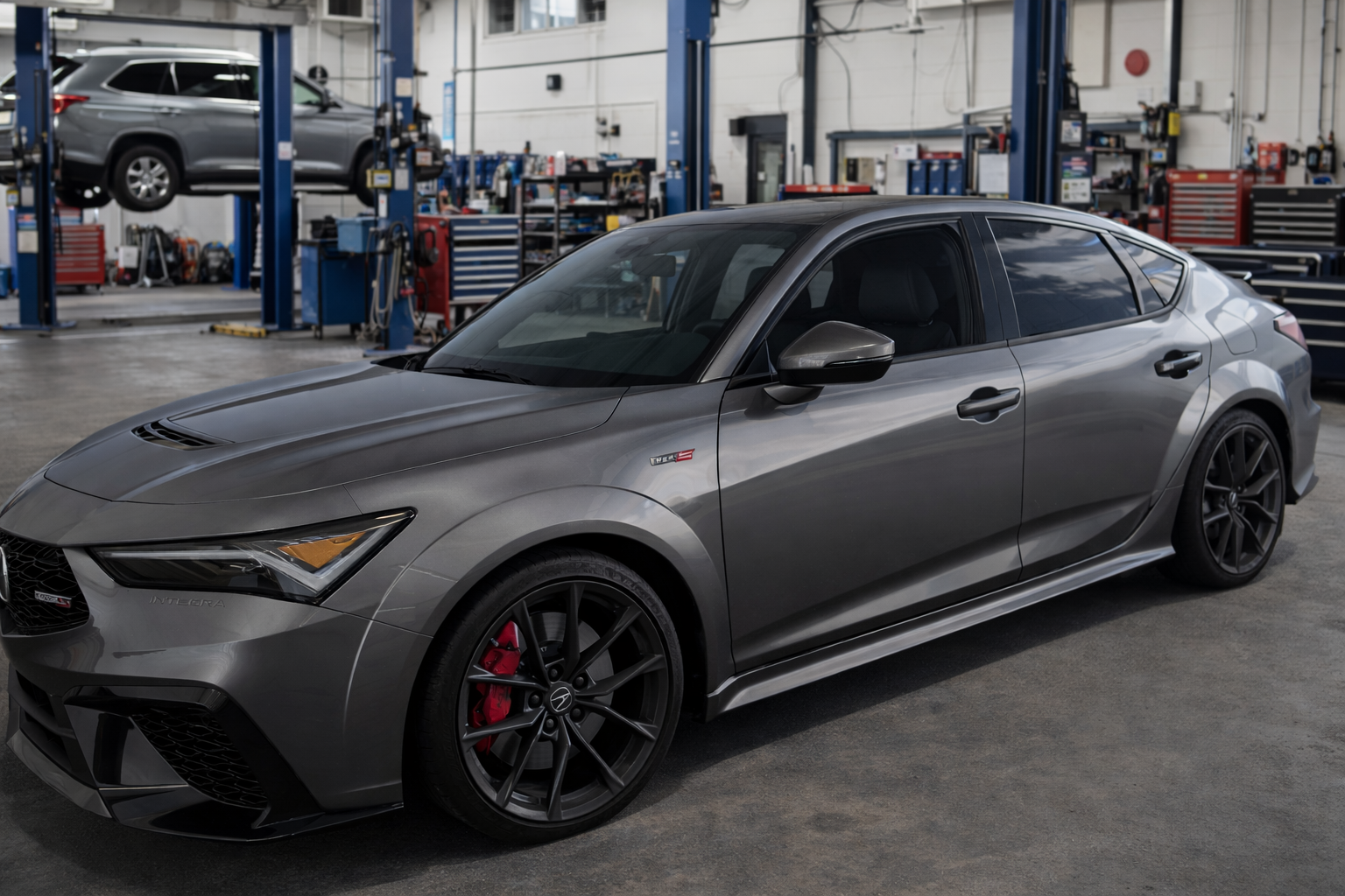 Matte black custom coupe with a low profile in a garage.