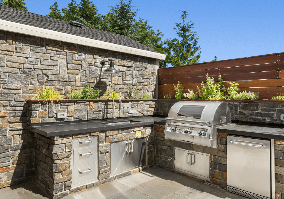 Stone outdoor kitchen living space 