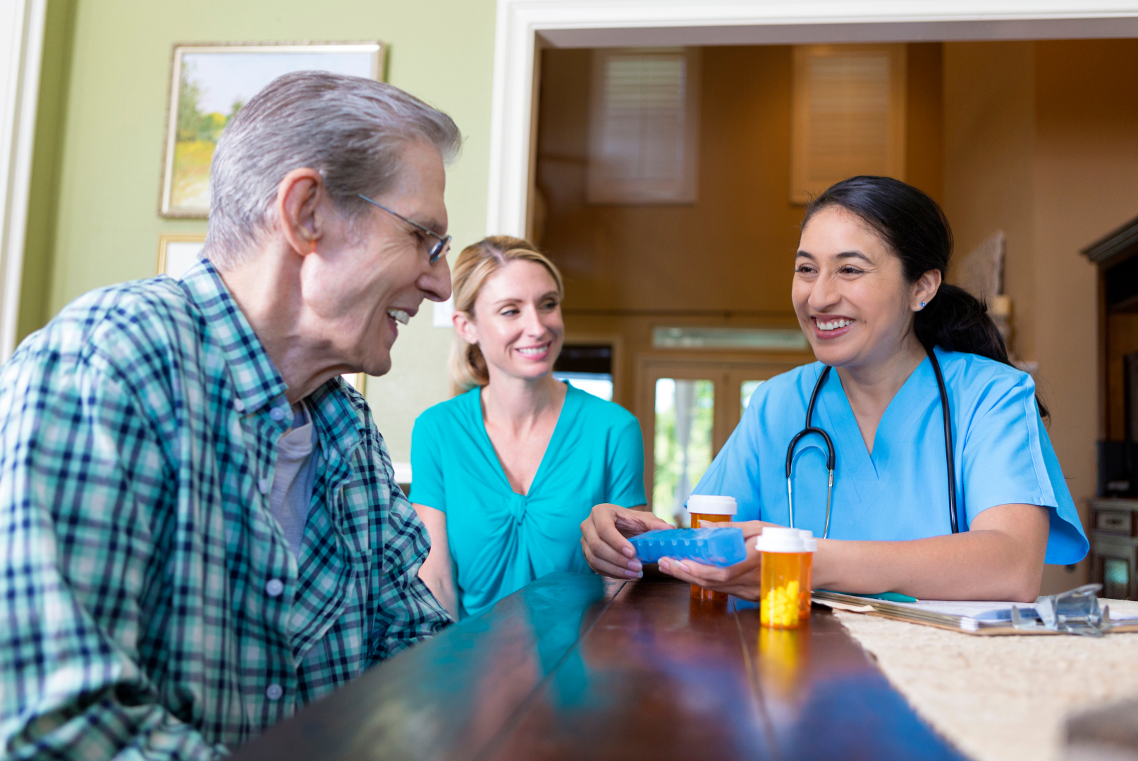 a nurse is giving an elderly man a pill box - Angel Leaf Home Care Provider