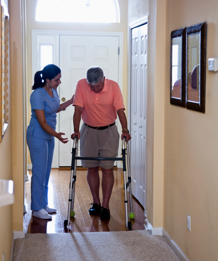 a man with a walker is being helped by a nurse Angel Leaf Home Care Provider