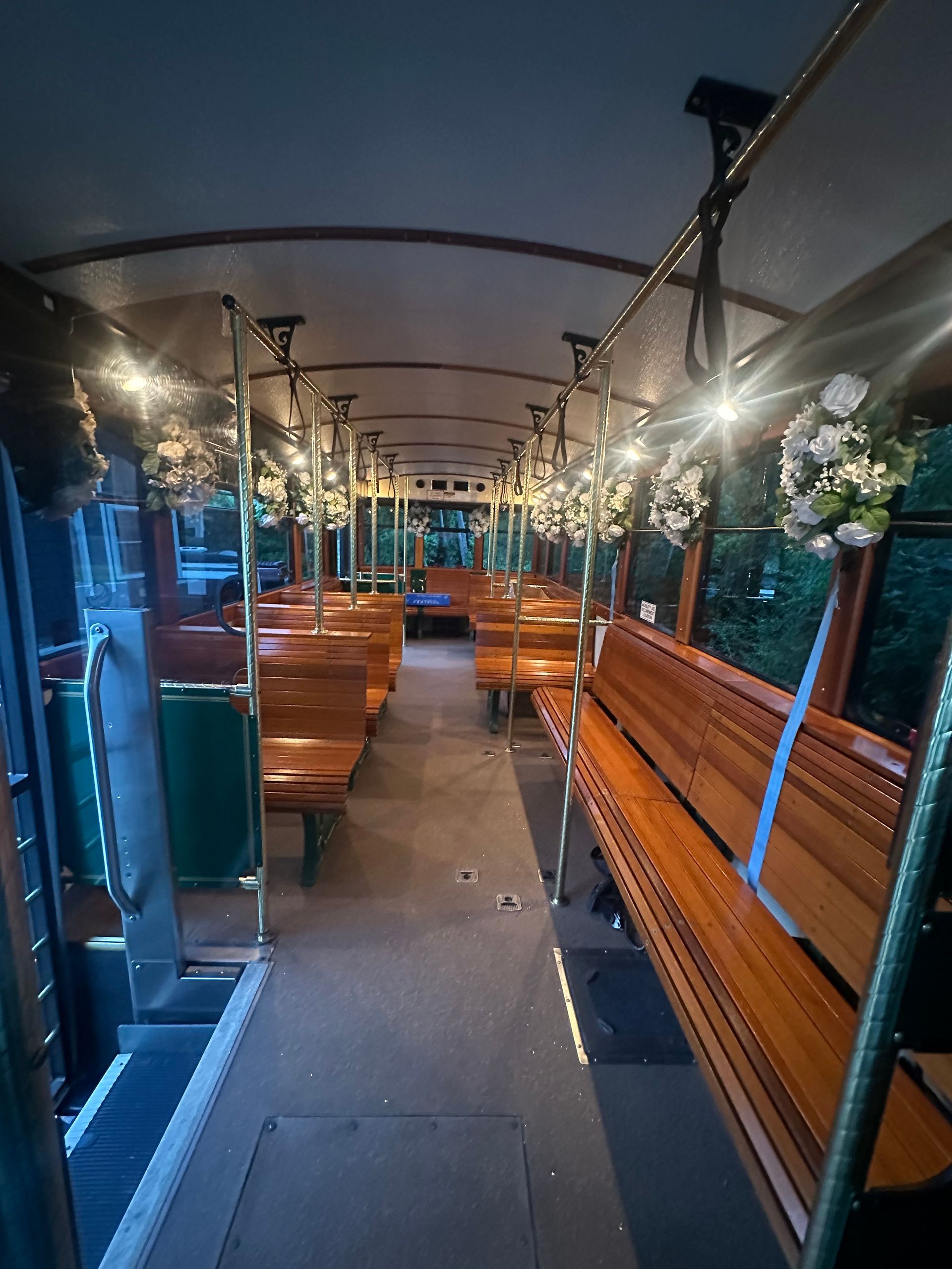 The inside of a bus decorated with flowers and lights