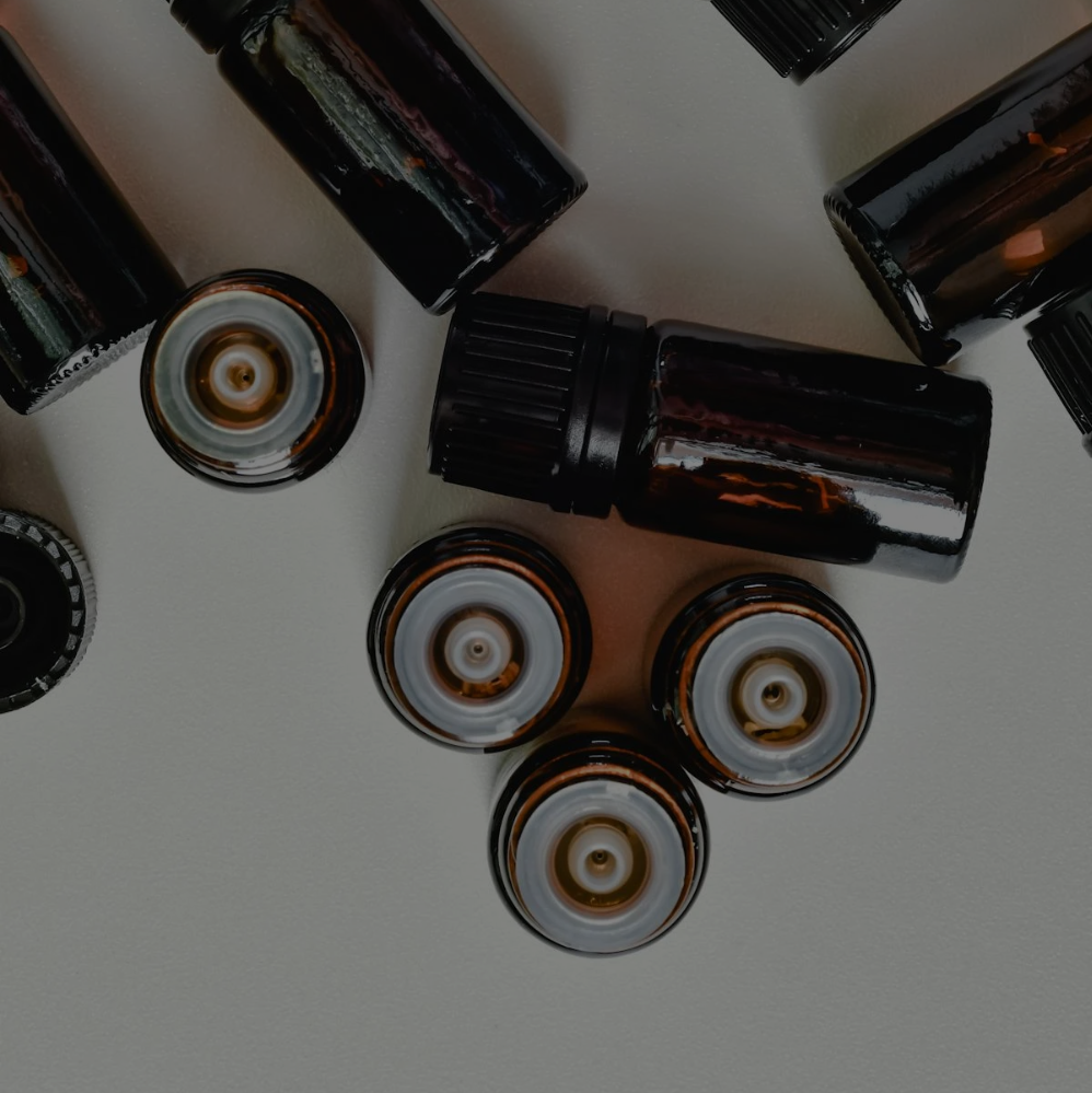 A bunch of black bottles with white caps on a table