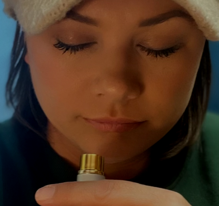 A close up of a woman holding a bottle in her hand
