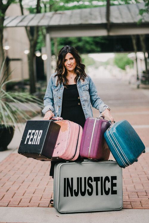 Holding baggage with names on it like Fear, injustice