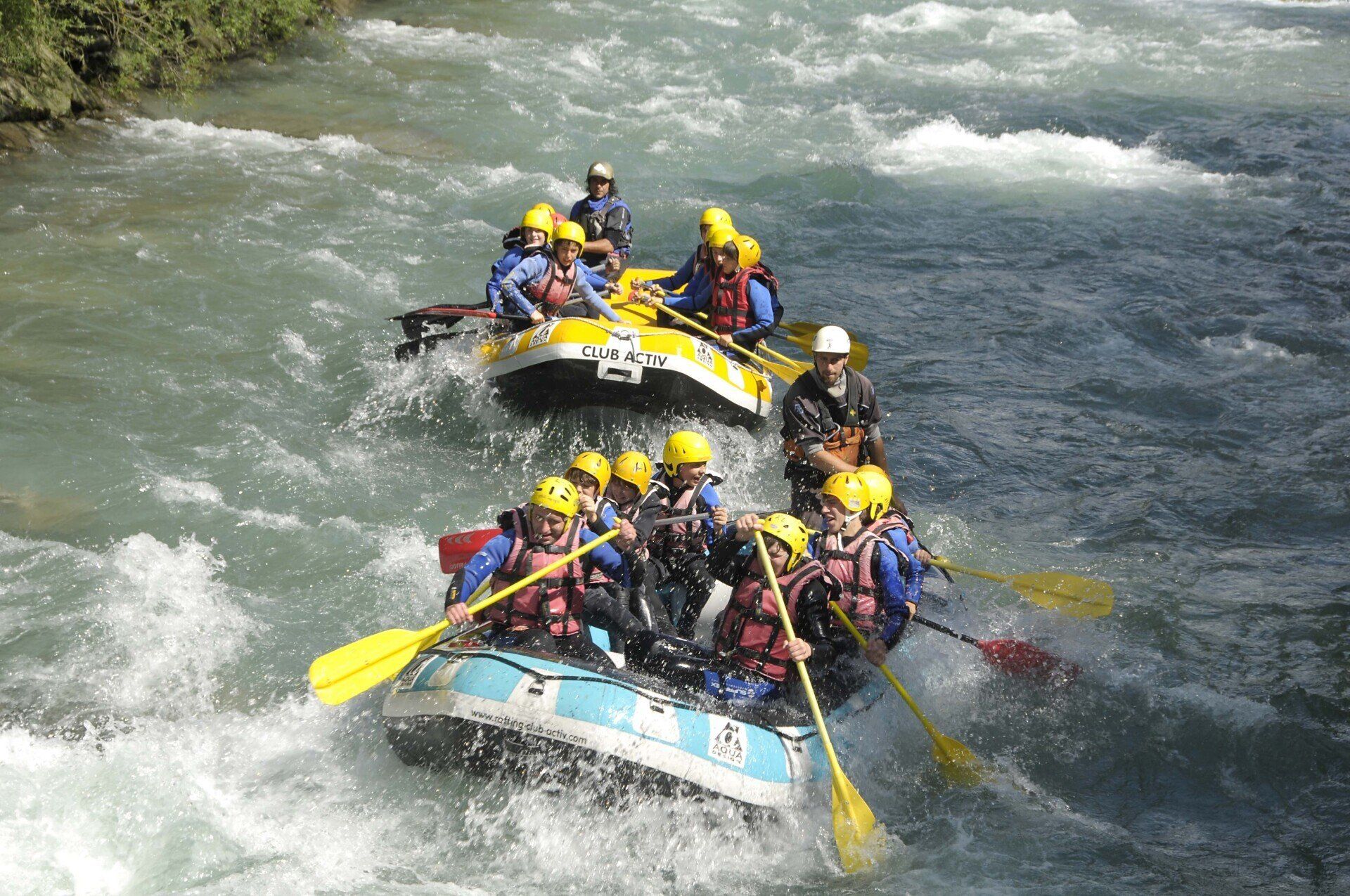 Eine Gruppe von Leuten macht eine Rafting-Tour auf einem Fluss.