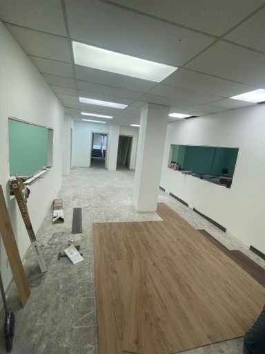 A large room with a wooden floor and a white ceiling.