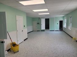 There is a mop bucket in the middle of the room.