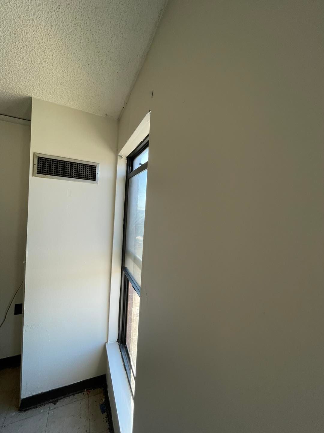 There is a window in the corner of the room.