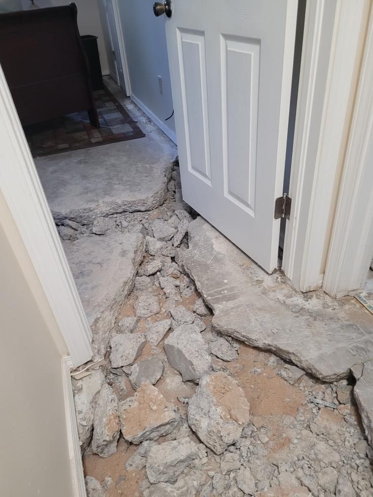 A room with a door and a lot of rocks on the floor.