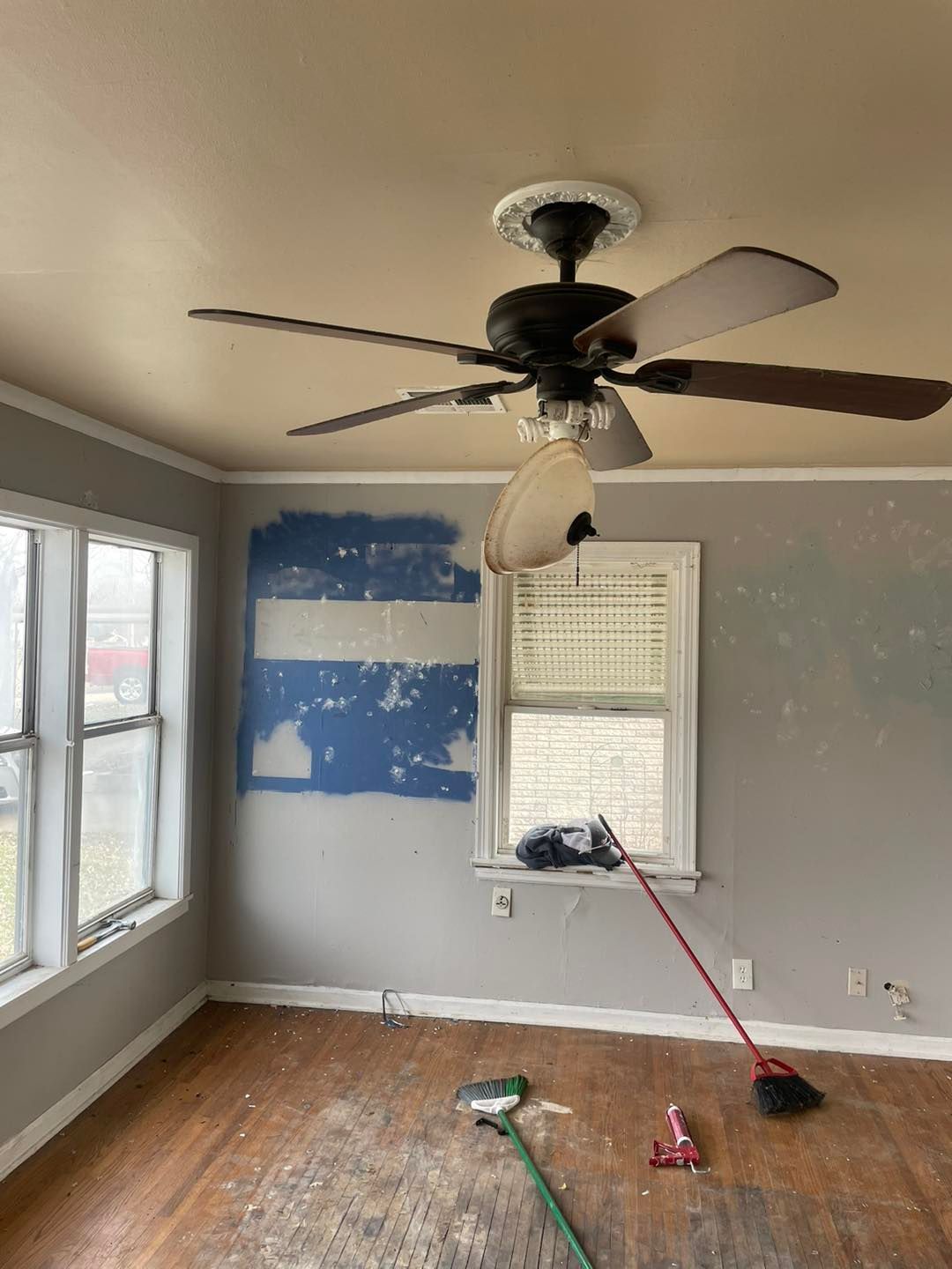 There is a ceiling fan in the corner of the room.