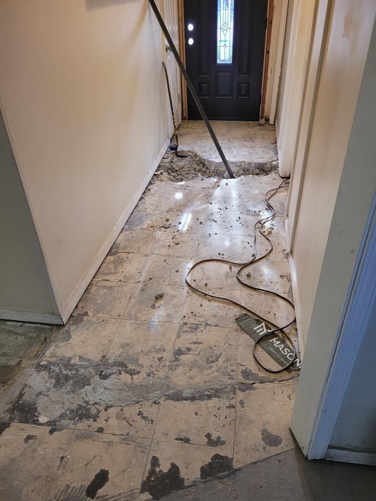 A hallway with a vacuum cleaner on the floor.