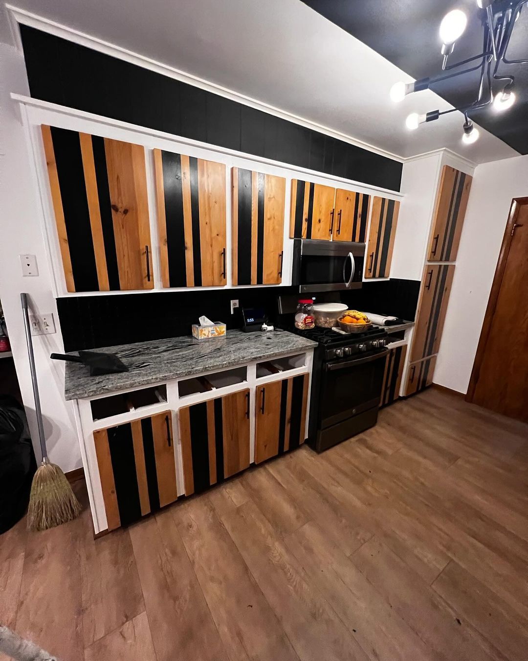 A kitchen with wooden cabinets and granite counter tops