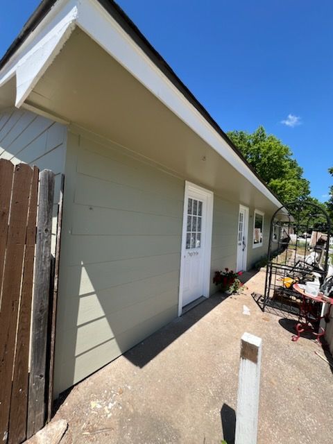 A house with a white door and a wooden fence