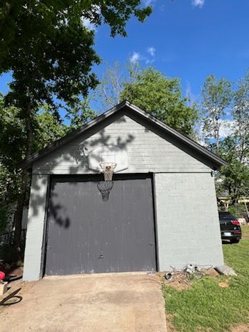 A garage with a basketball hoop on top of it.