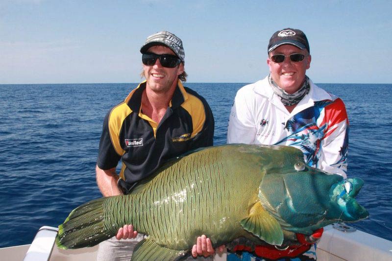 Two people holding fish — daly river fishing in Winnellie, NT