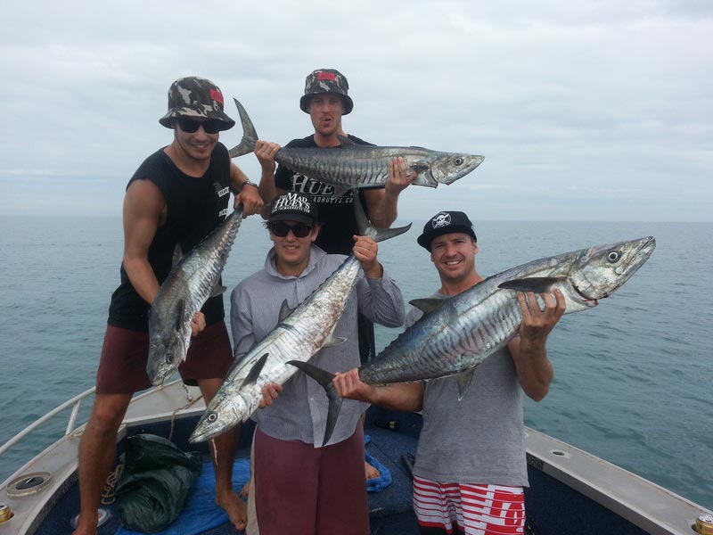 Four men carrying their fish caught — Dean Jackson Guided Tours in Winnellie, NT