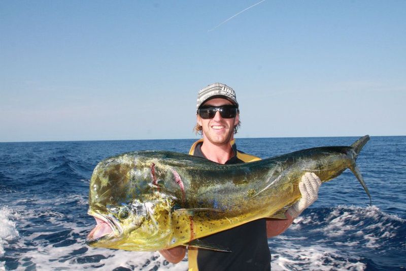 Man carrying bigger fish — Dean Jackson Guided Tours in Winnellie, NT