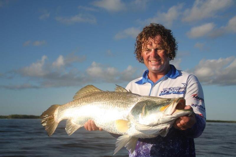 Man carrying bigger fish 2 — Dean Jackson Guided Tours in Winnellie, NT