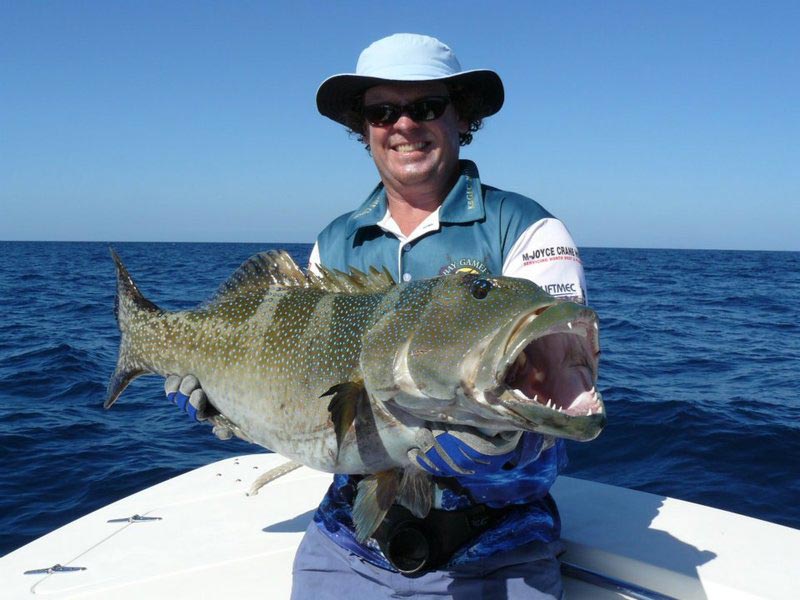 Man carrying bigger fish 5 — Dean Jackson Guided Tours in Winnellie, NT