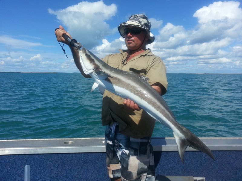 Man carrying bigger fish 7 — Dean Jackson Guided Tours in Winnellie, NT