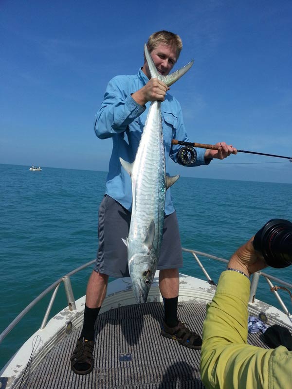 Man carrying bigger fish 8 — Dean Jackson Guided Tours in Winnellie, NT