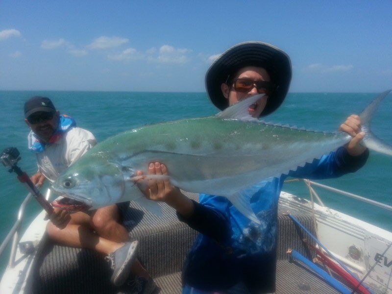 Man carrying bigger fish 10 — Dean Jackson Guided Tours in Winnellie, NT