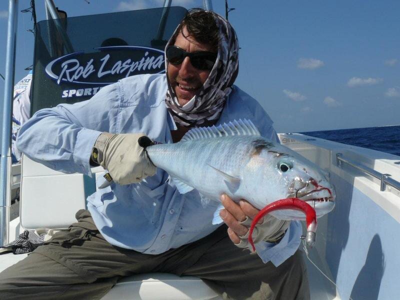 Man carrying blue fish — Dean Jackson Guided Tours in Winnellie, NT