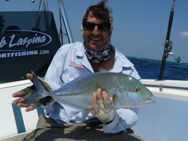 man carrying fish — Dean Jackson Guided Tours in Winnellie, NT